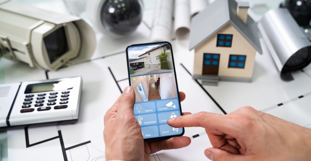 Person holding a phone looking at CCTV System